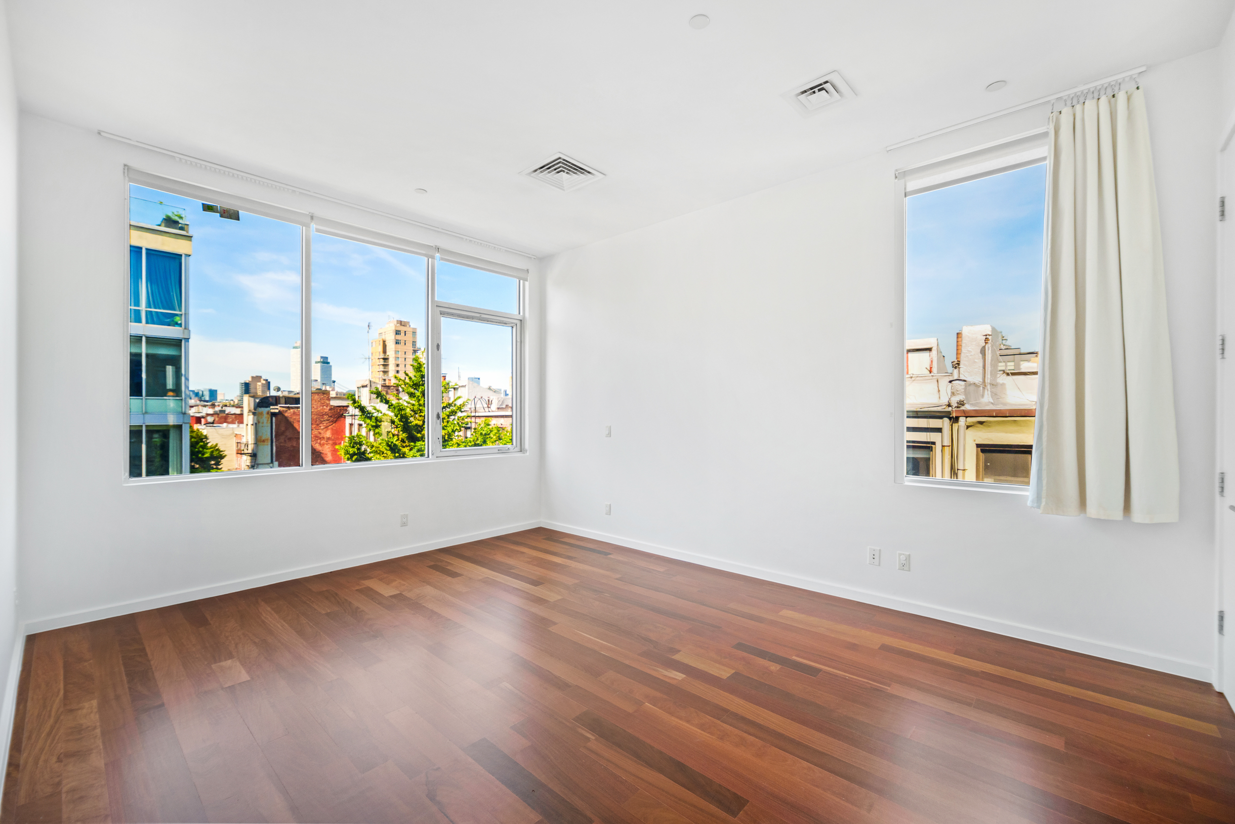 170 North 11th Street, Unit 5B Brooklyn, NY 11211 - Photo 6 of 11 an empty room with wooden floor and windows