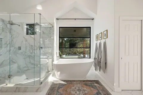 a bathroom with a bathtub and shower