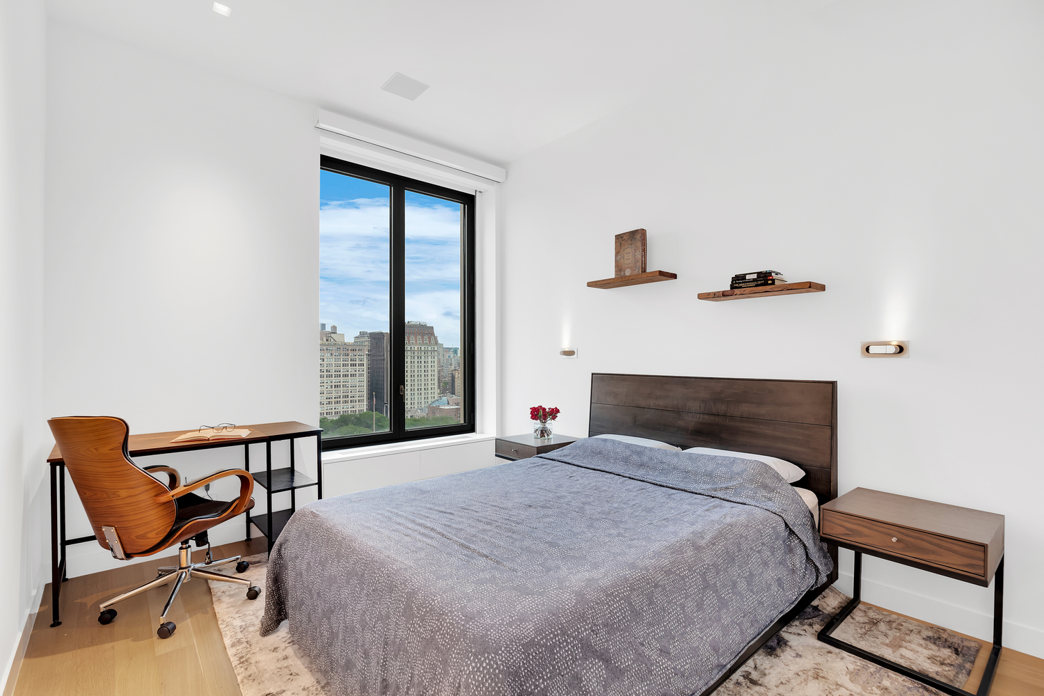 21 East 12th Street, Unit 19B Manhattan, NY 10003 - Photo 10 of 17 a bedroom with a bed and wooden floor
