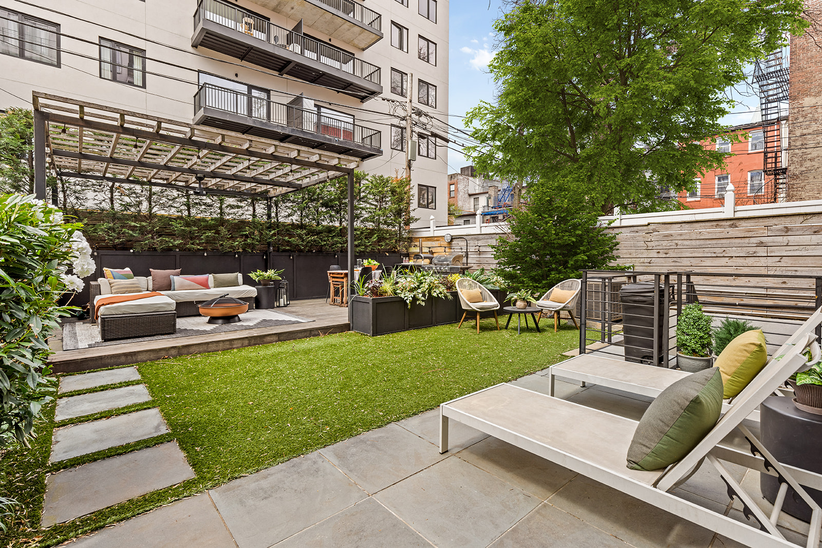 516 Classon Avenue, Unit 1B Brooklyn, NY 11238 - Photo 2 of 17 a view of a patio with couches chairs and a big yard