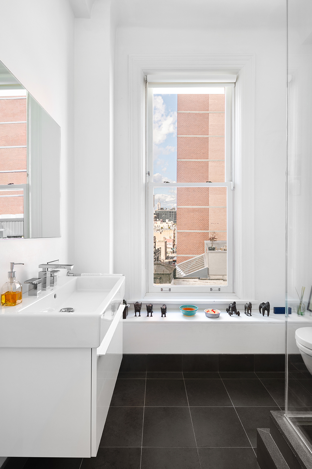 366 Broadway, Unit 8A Manhattan, NY 10013 - Photo 8 of 13 a bathroom with a double vanity sink and a bathtub
