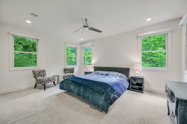 a spacious bedroom with a bed and a window