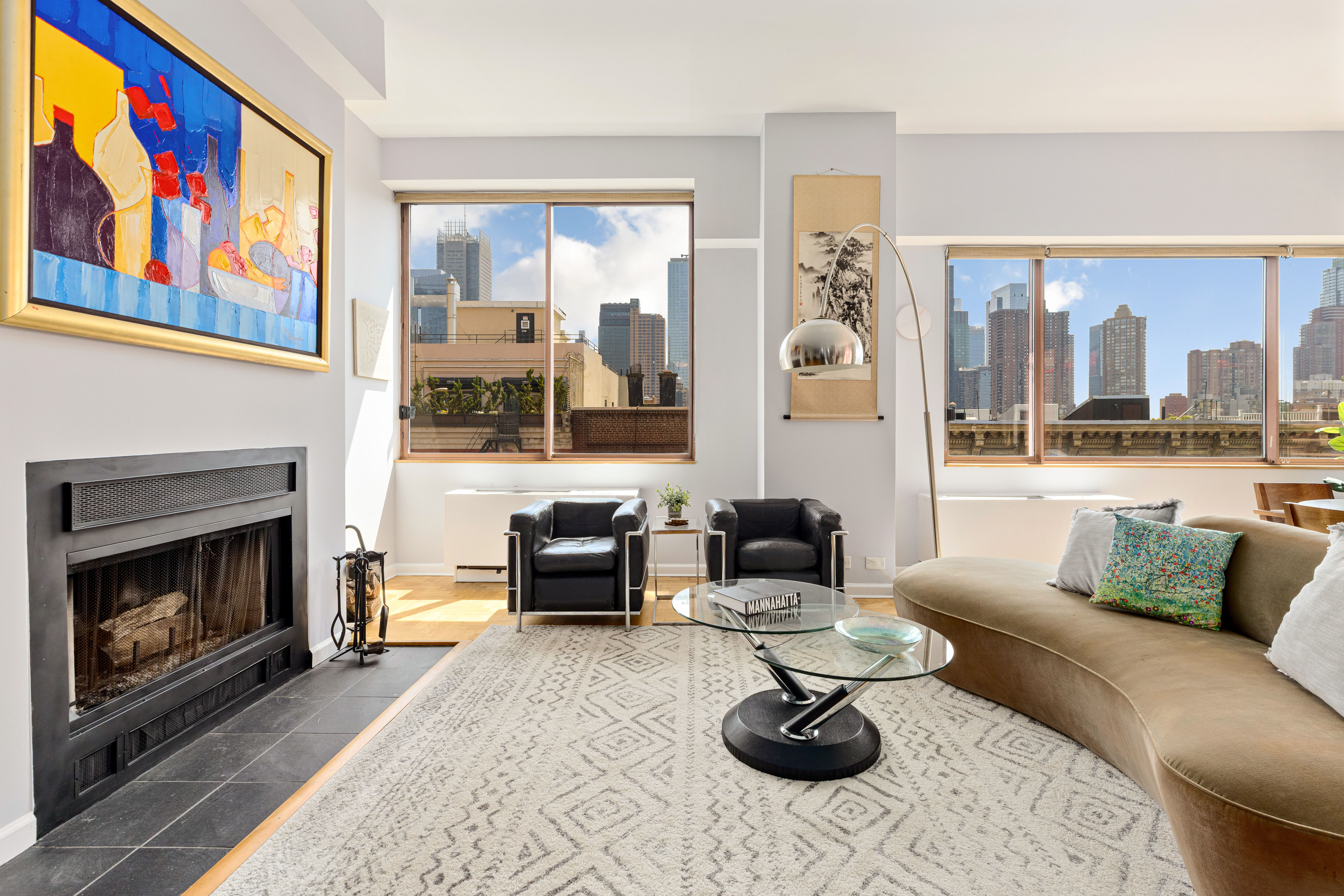 393 West 49th Street, Unit 5C Manhattan, NY 10019 - Photo 6 of 21 a living room with furniture and a fireplace