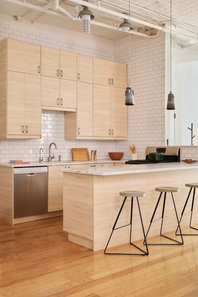 a kitchen with stainless steel appliances granite countertop a sink a stove and white cabinets