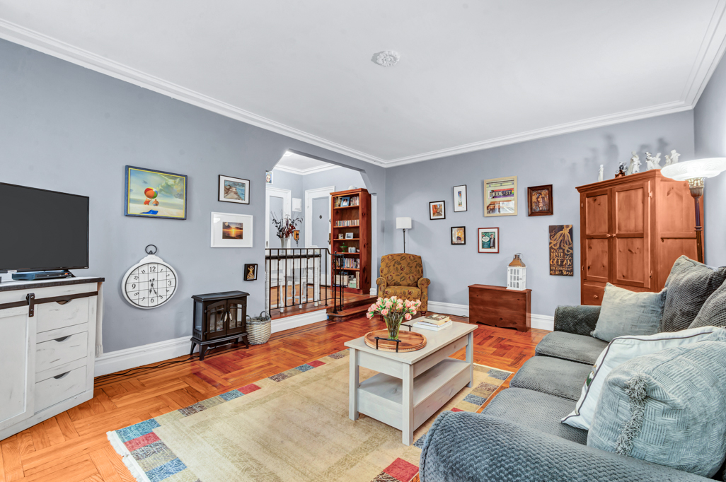 350 Cabrini Boulevard, Unit 6N Manhattan, NY 10040 - Photo 2 of 9 a living room with furniture and a flat screen tv