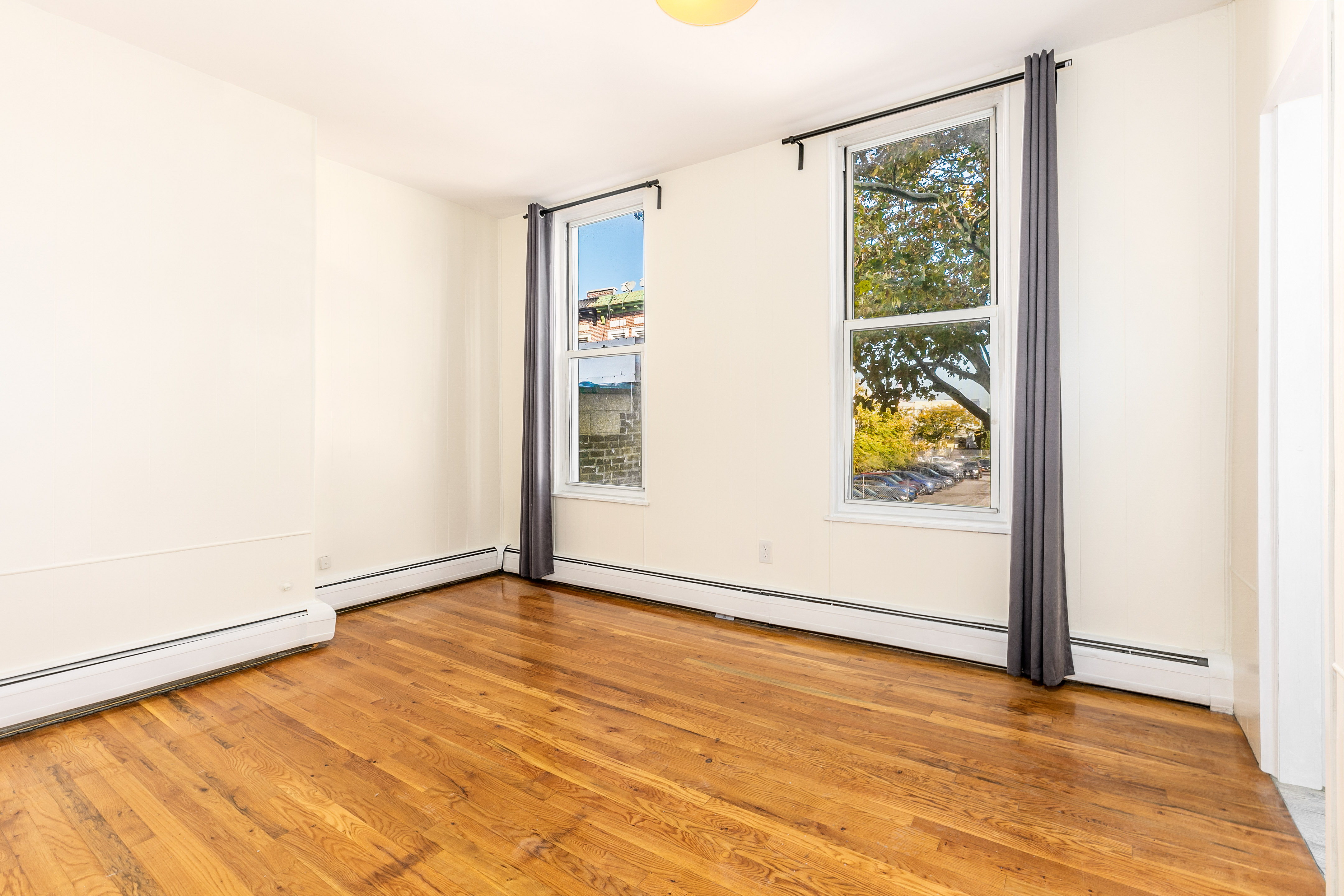 148 29th Street Brooklyn, NY 11232 - Photo 14 of 31 a view of an empty room with window and wooden floor