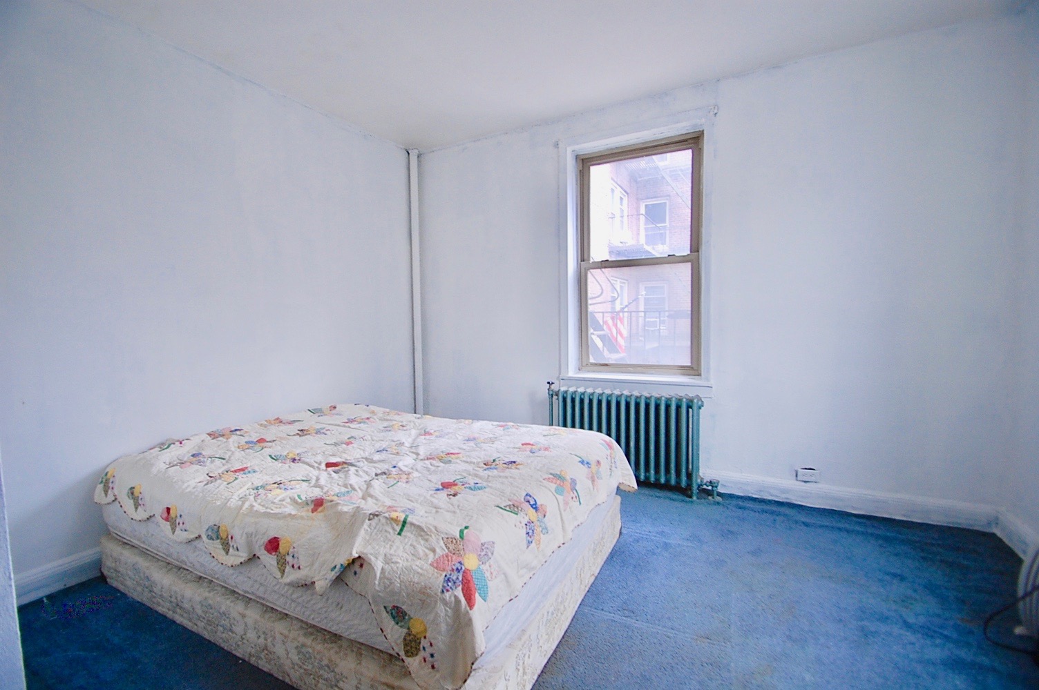 43-10 48th Avenue, Unit 2P Queens, NY 11377 - Photo 5 of 9 a bedroom with a bed and wooden floor