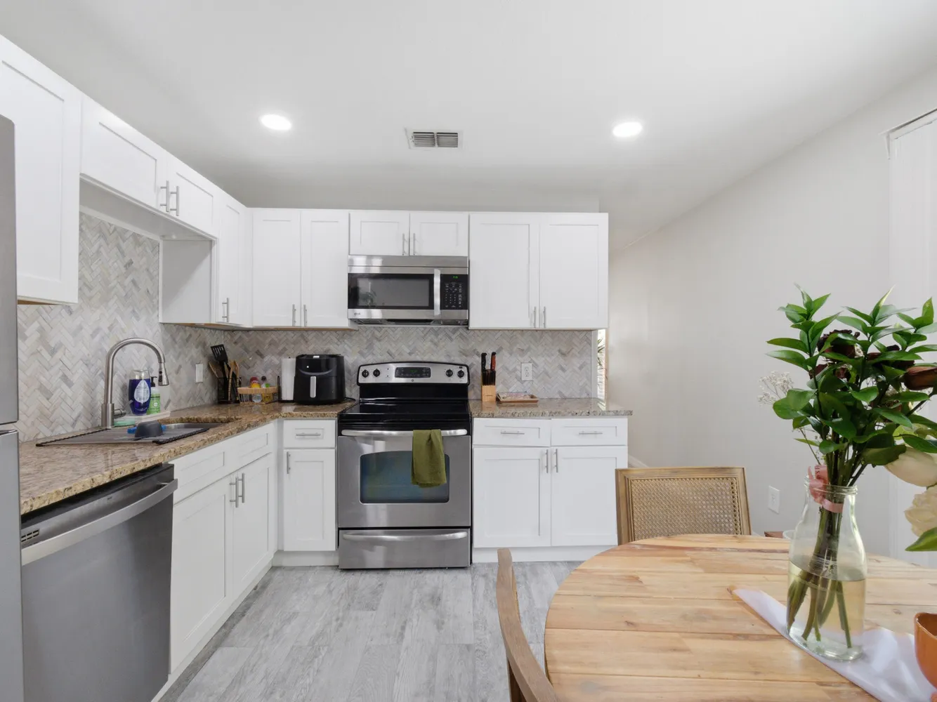a kitchen with a sink a stove cabinets and counter space