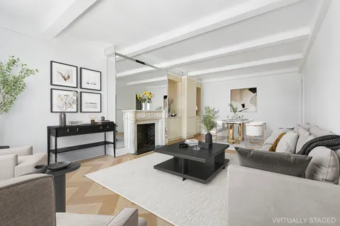 a living room with furniture a fireplace and a table