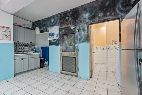 a kitchen with a refrigerator and cabinets