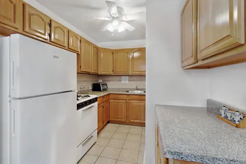 a kitchen with stainless steel appliances granite countertop a refrigerator a stove a sink and dishwasher