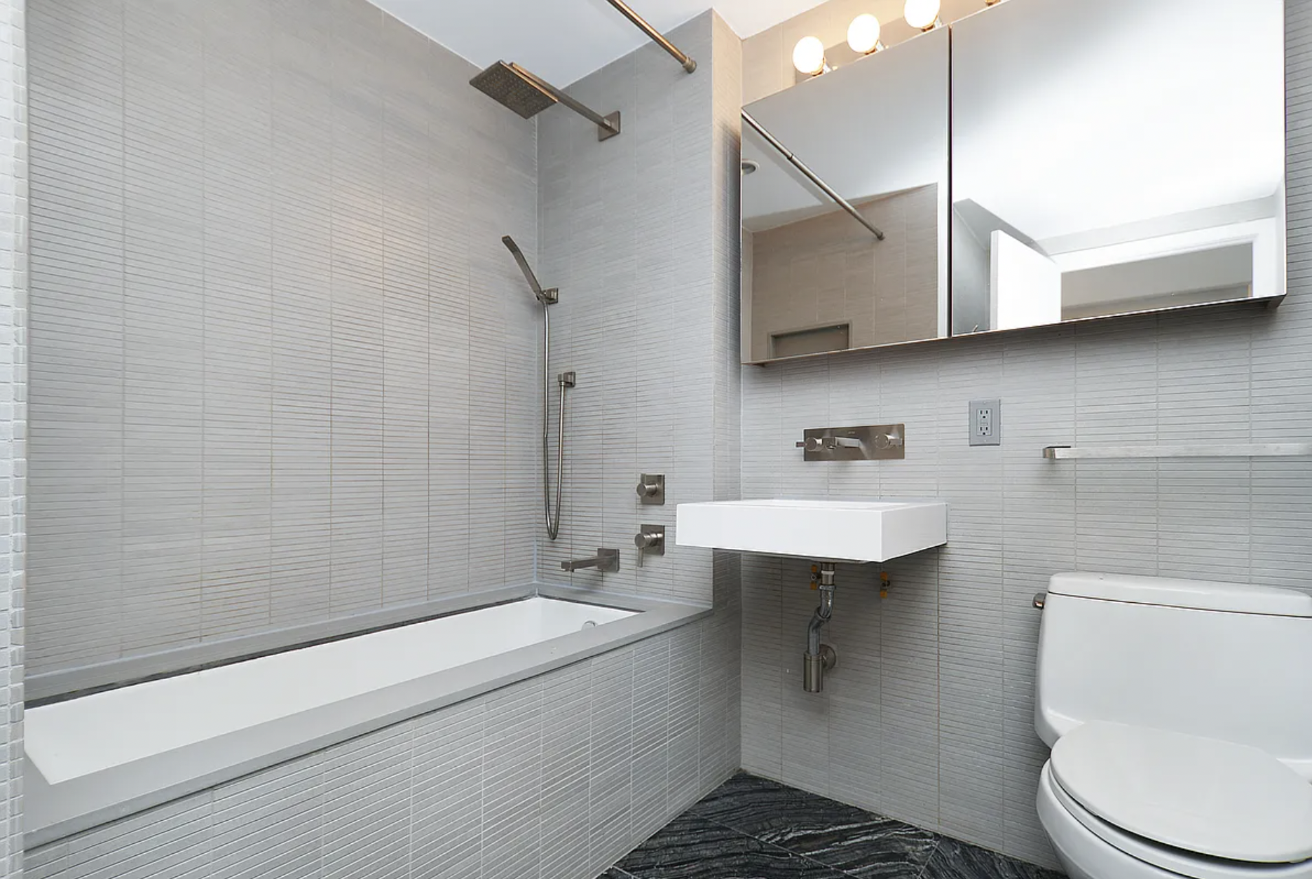 250 Bedford Avenue, Unit 129211 Brooklyn, NY 11249 - Photo 4 of 6 a bathroom with a sink a toilet and shower