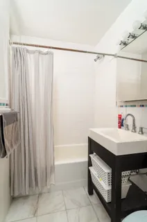 a utility room with shower and mirror