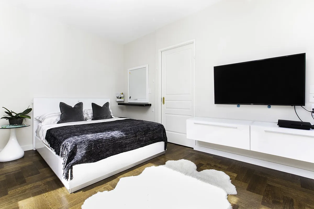 220 Riverside Boulevard, Unit 4D Manhattan, NY 10069 - Photo 8 of 15 a bedroom with a bed and a flat screen tv