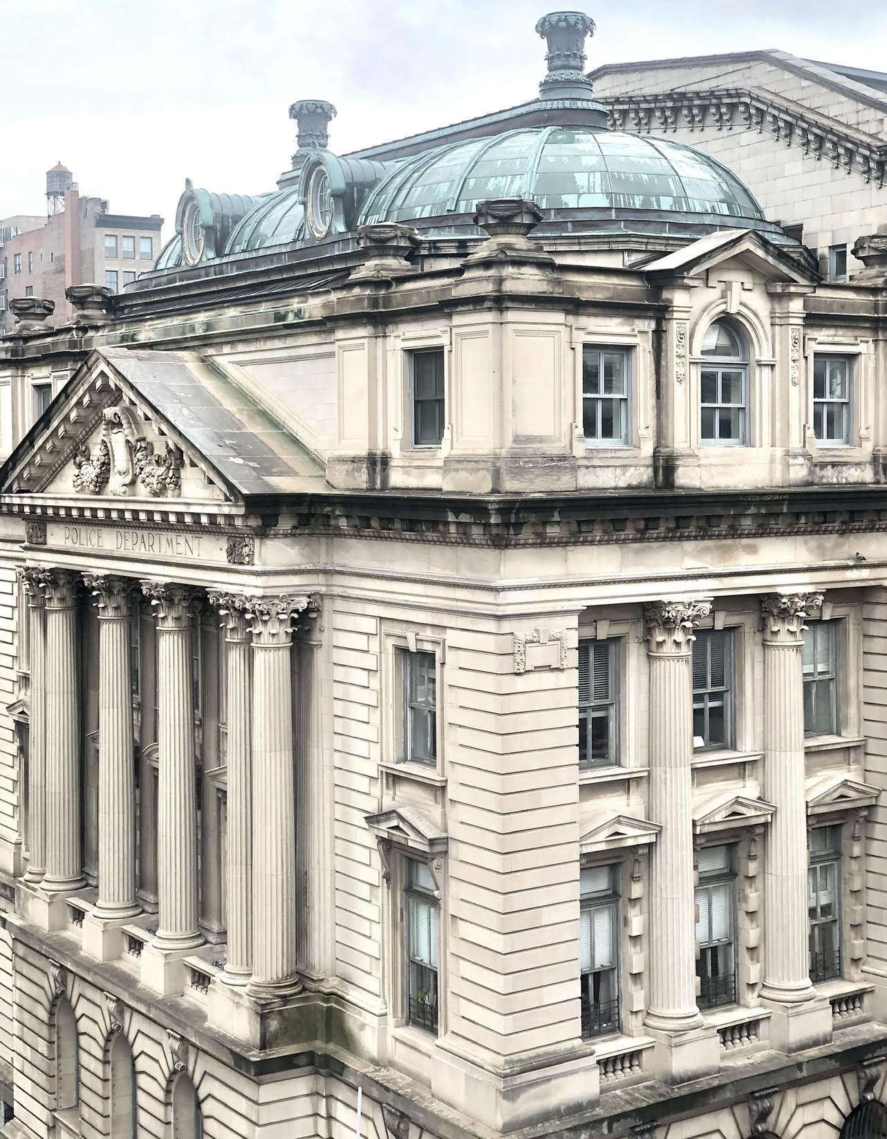 240 Centre Street, Unit 3B Manhattan, NY 10013 - Photo 22 of 23 a front view of a building with a lot of windows