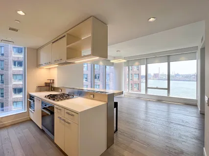 a kitchen with stove and wooden floor