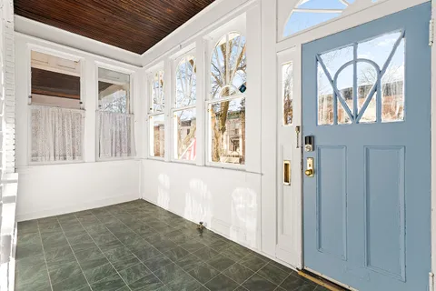 a view of an entryway with wooden floor