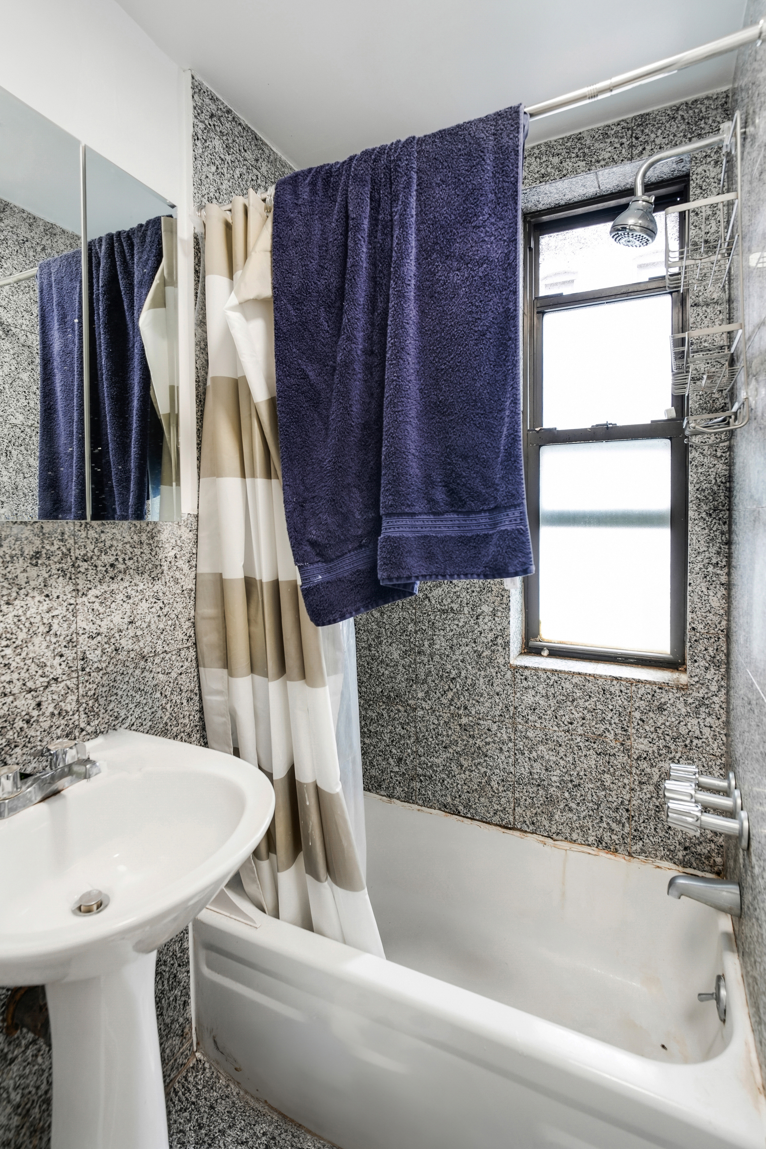 214 East 82nd Street, Unit 27 Manhattan, NY 10028 - Photo 6 of 6 a bathroom with a bathtub a sink a toilet and a shower