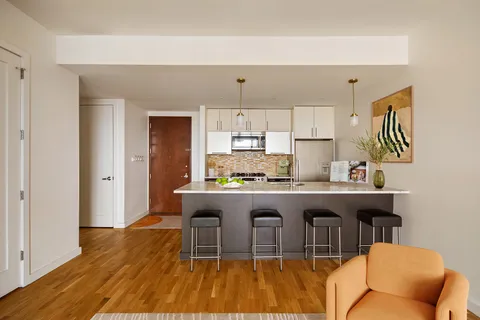 a kitchen with a sink cabinets and wooden floor