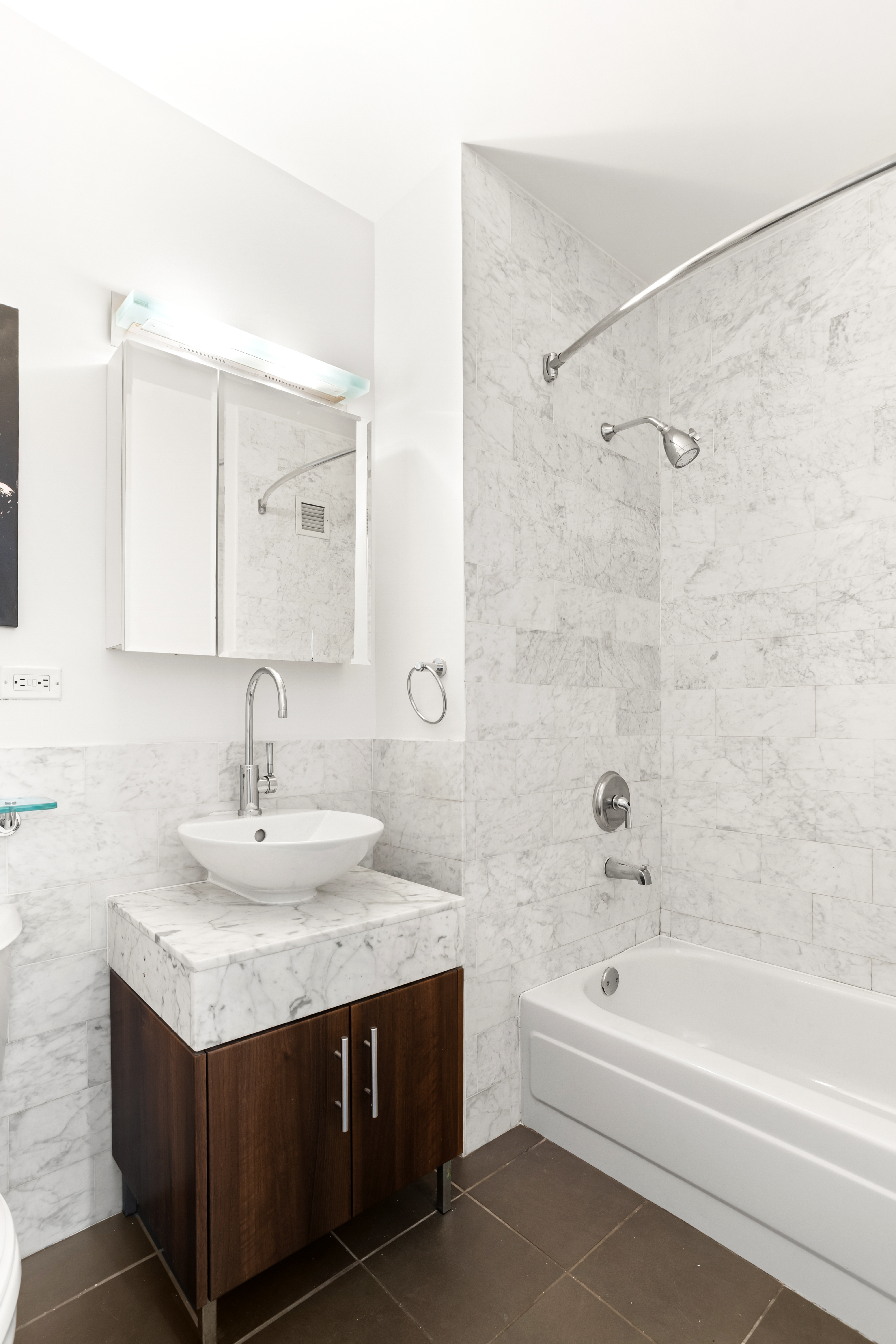 1 Wall Street Court, Unit 506 Manhattan, NY 10005 - Photo 3 of 8 a bathroom with a sink vanity tub and shower