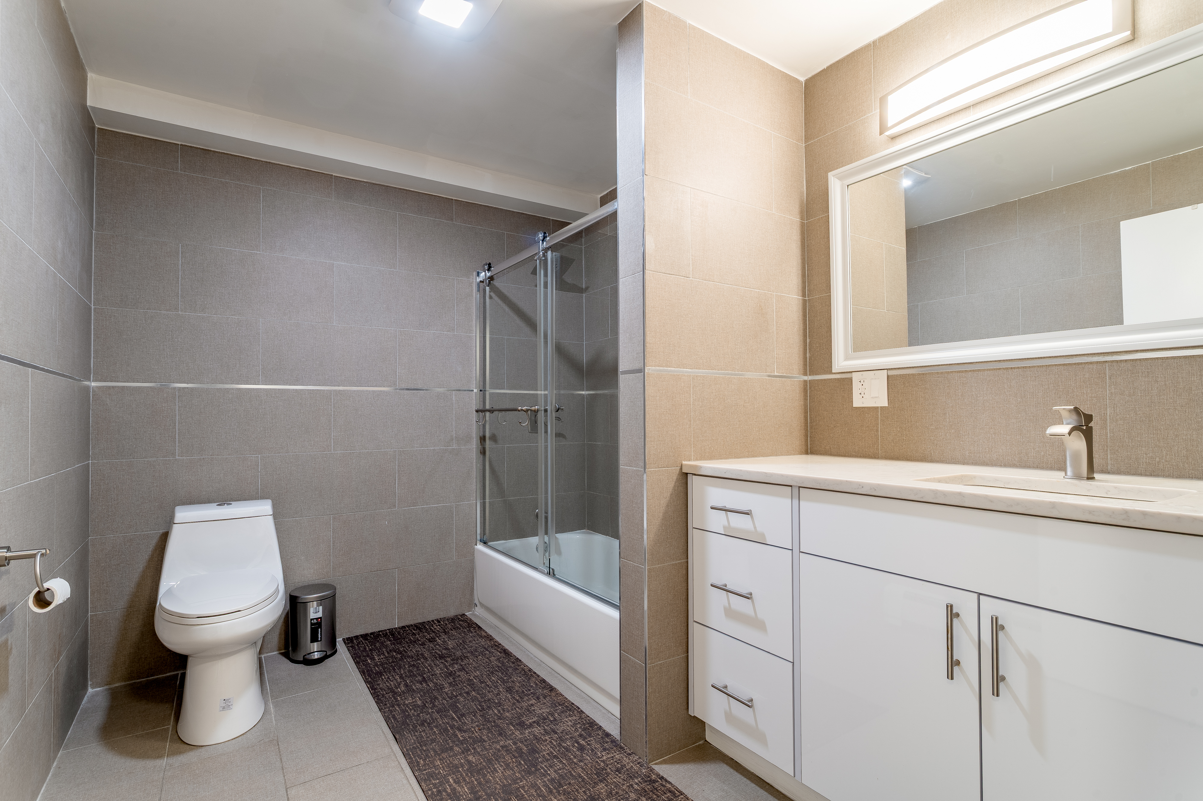 212 East 70th Street, Unit B Manhattan, NY 10021 - Photo 12 of 17 a bathroom with a sink a toilet and shower