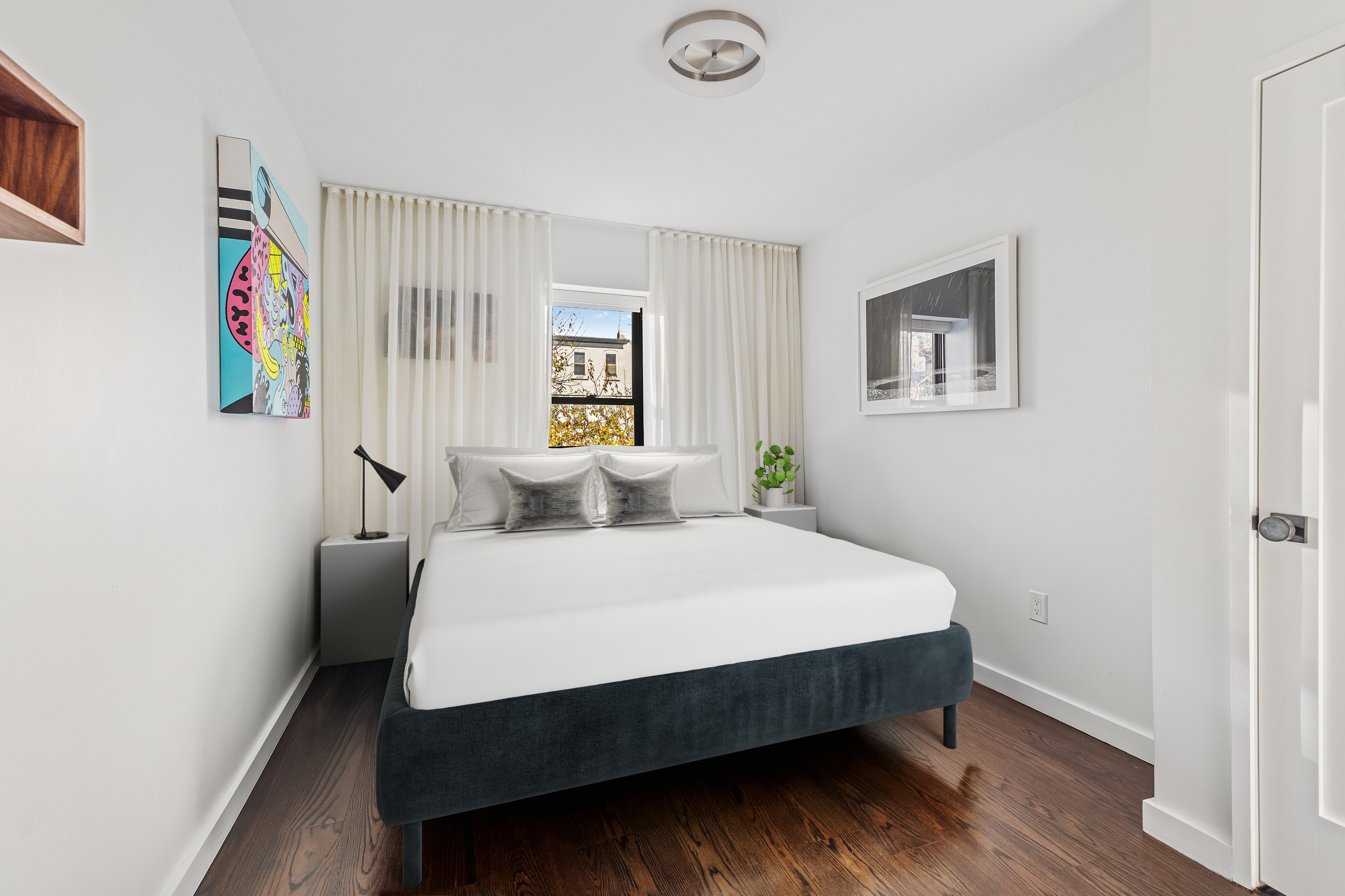 211 14th Street Brooklyn, NY 11215 - Photo 7 of 18 a bed room with a bed and a window