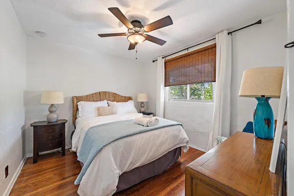 a bedroom with a bed and a window