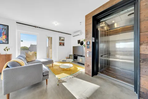 a living room with furniture and a chandelier