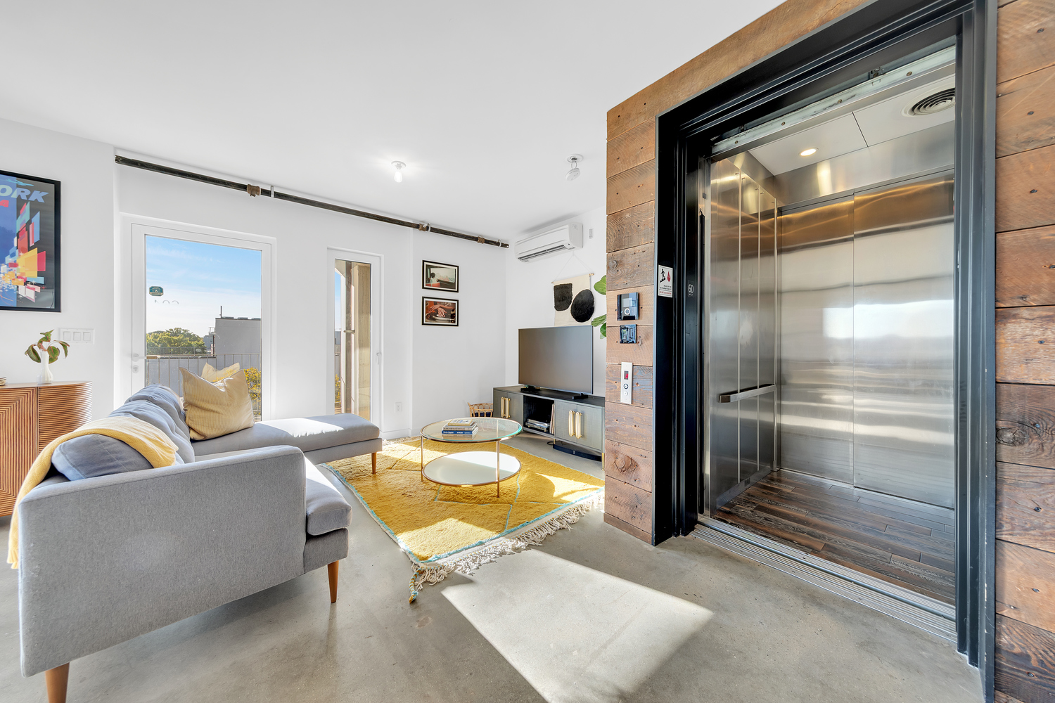651 New York Avenue, Unit 604 Brooklyn, NY 11203 - Photo 11 of 13 a living room with furniture and a chandelier