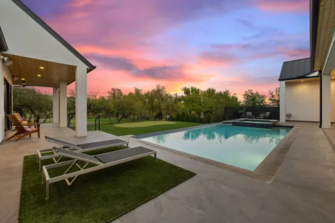 a view of a swimming pool with sitting area