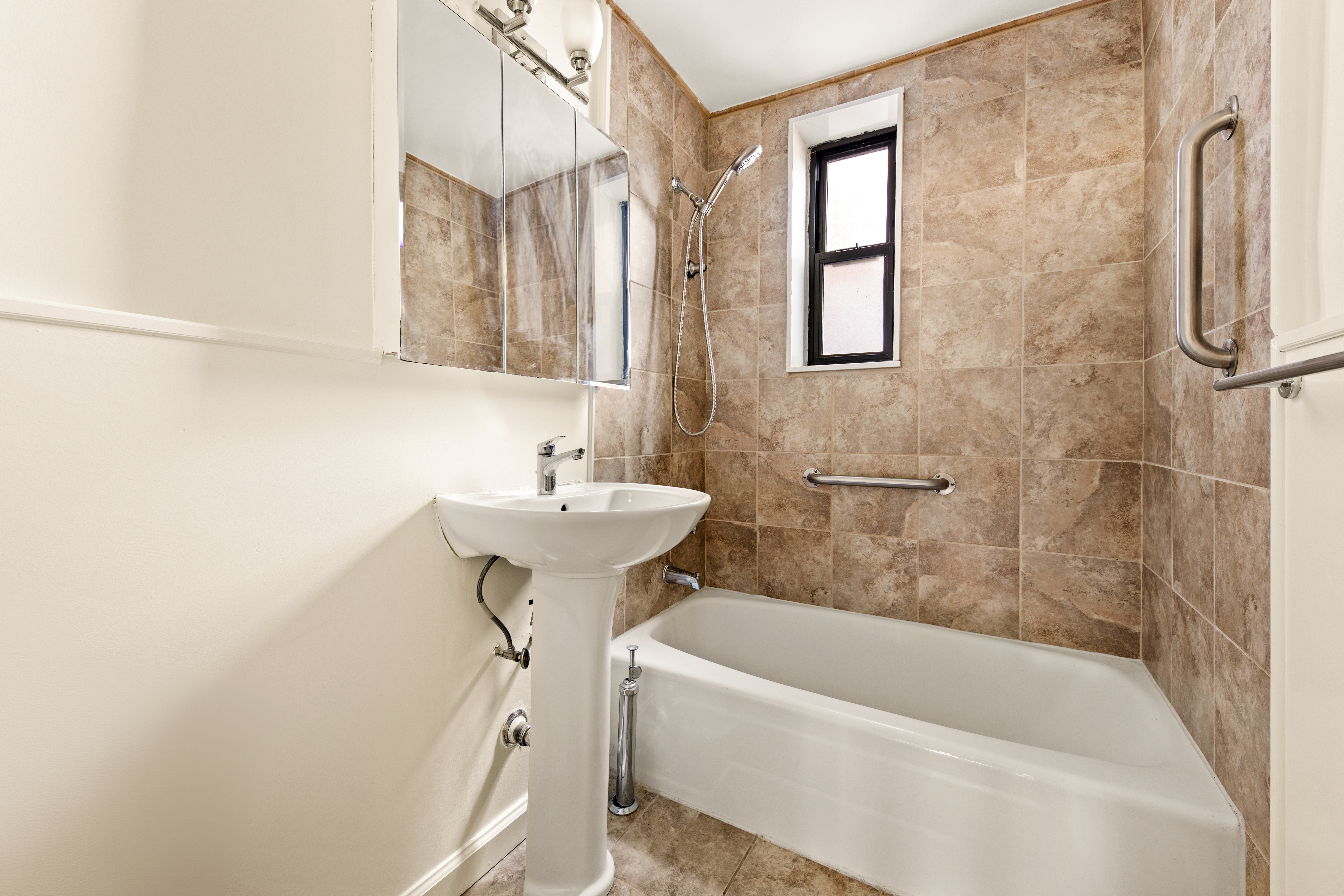 185 Prospect Park Southwest, Unit 301 Brooklyn, NY 11218 - Photo 7 of 9 a bathroom with a sink a bathtub and shower