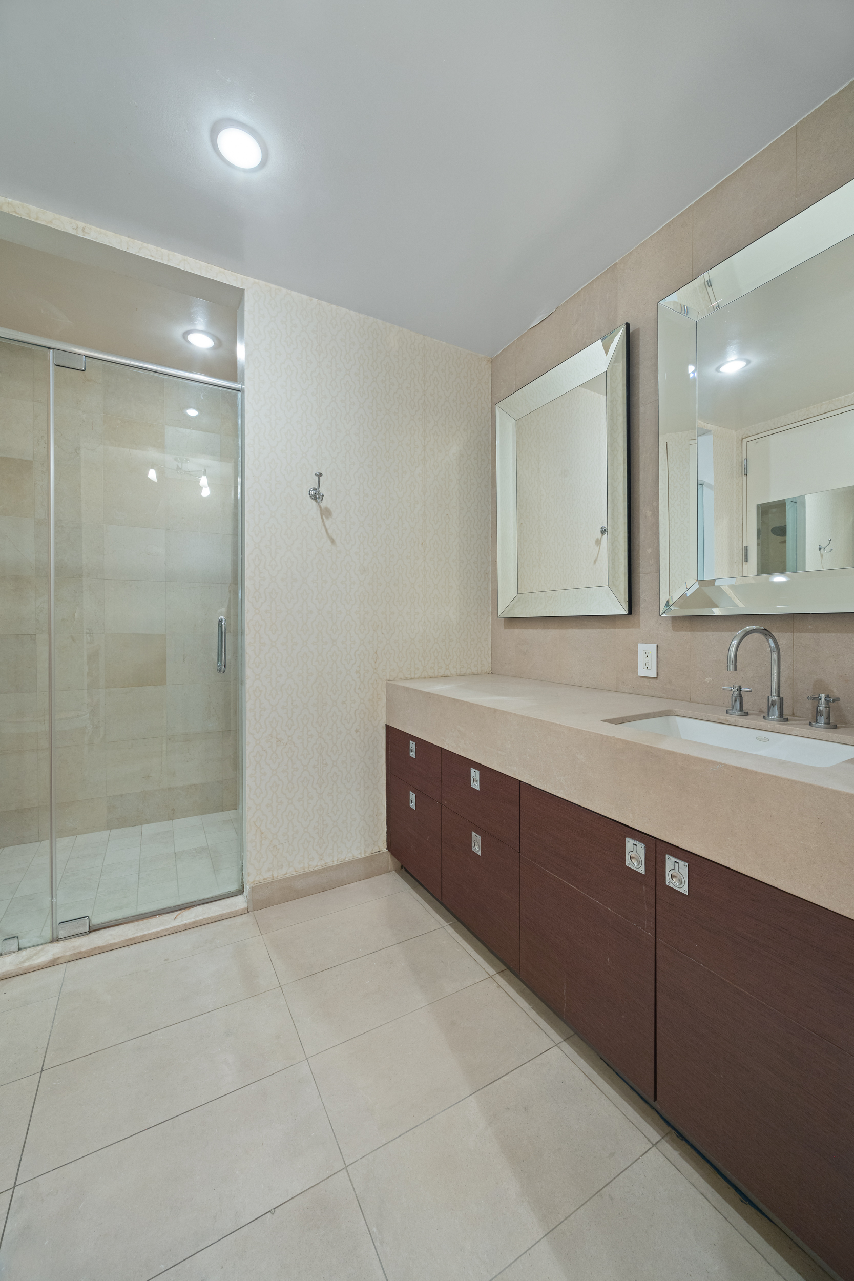 157 East 84th Street, Unit THA Manhattan, NY 10028 - Photo 26 of 33 a spacious bathroom with a shower sink and mirror