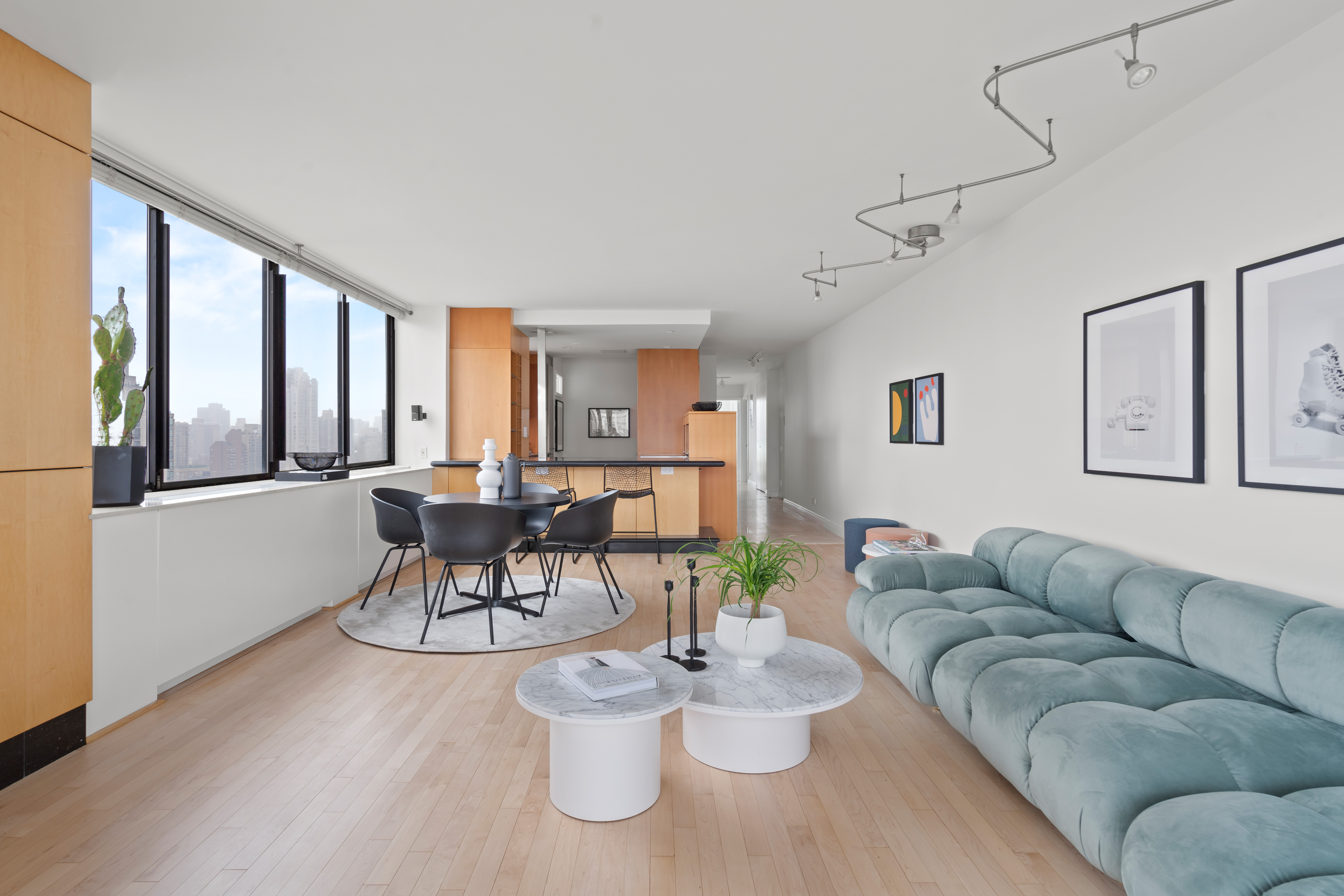 330 East 75th Street, Unit 32A Manhattan, NY 10021 - Photo 4 of 17 a living room with furniture and a large window