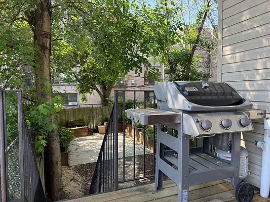 730 Quincy Street, Unit 2 Brooklyn, NY 11221 - Photo 7 of 11 a view of a patio with table and chairs with wooden fence and plants