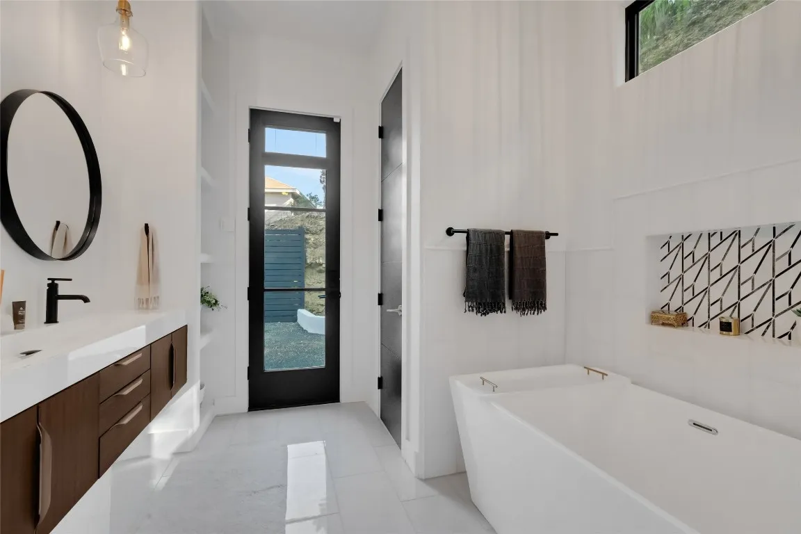a white bath tub sitting next to a white sink