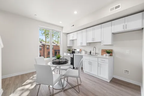 a kitchen with a table and chairs in it
