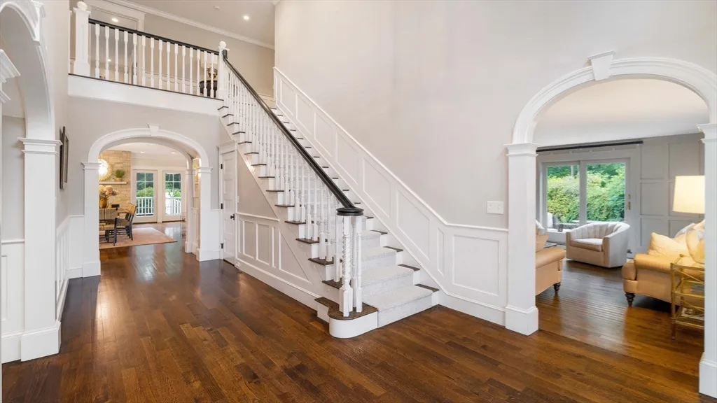 a view of entryway with wooden floor and stairs