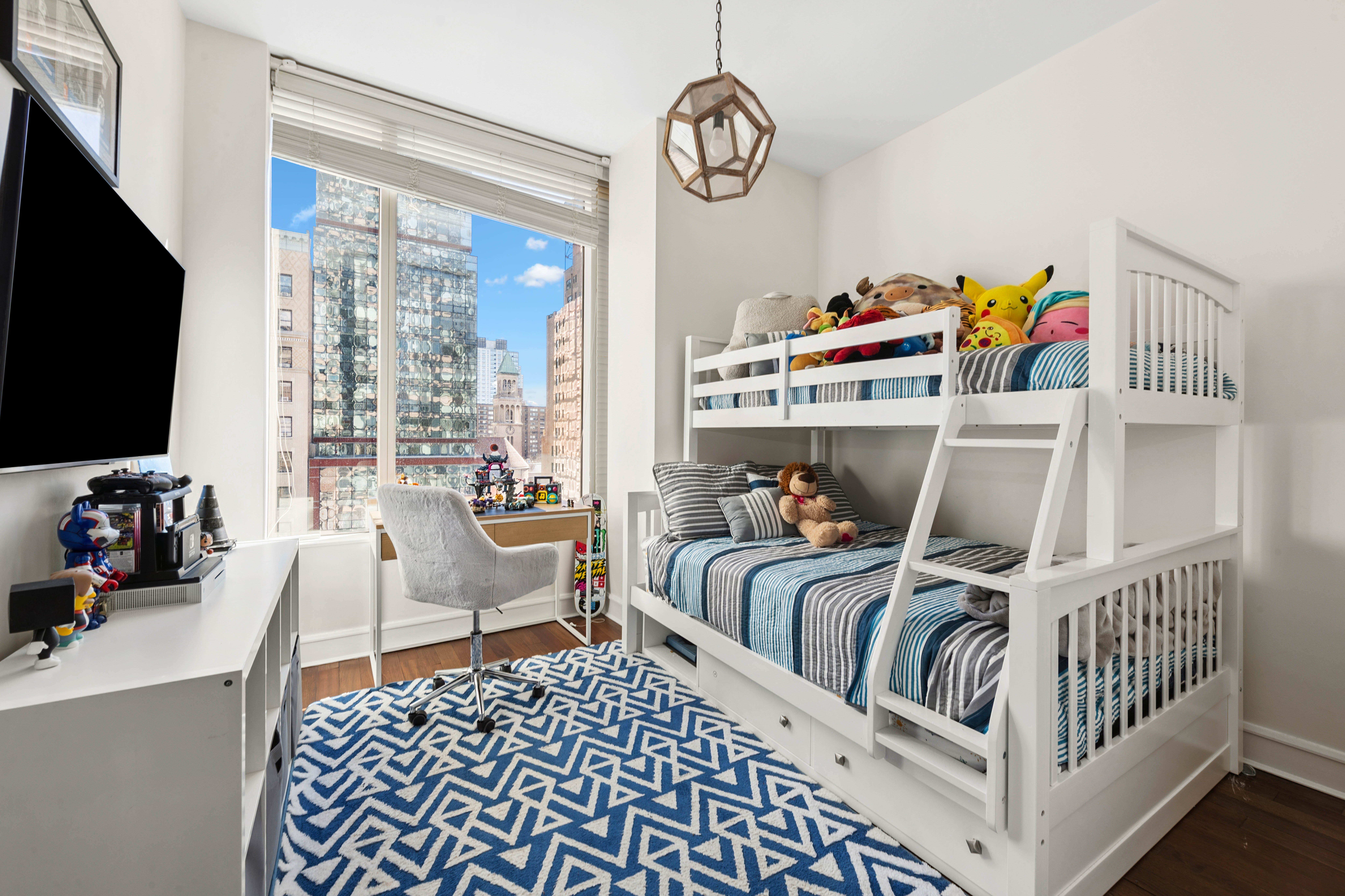 245 West 99th Street, Unit 8A Manhattan, NY 10025 - Photo 9 of 12 a bedroom with furniture and a flat screen tv