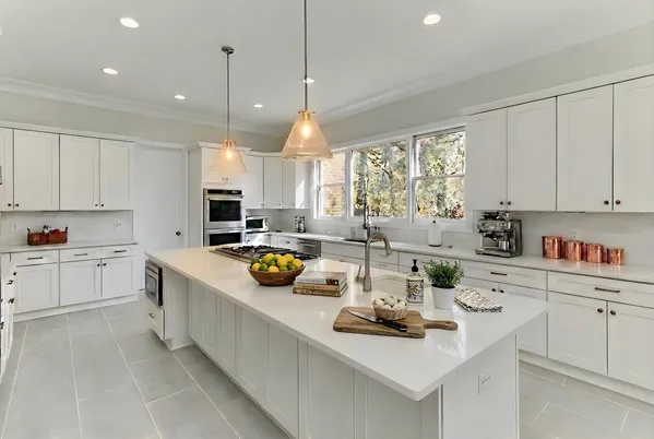 a kitchen that has a lot of cabinets in it and appliances