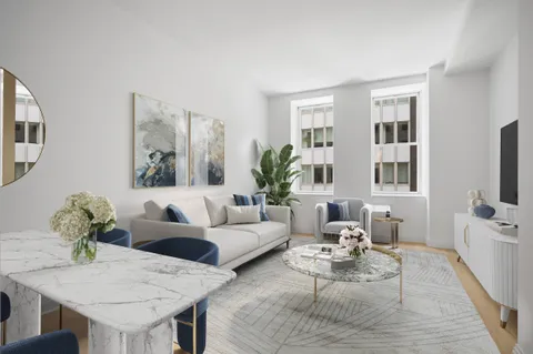 a living room with furniture potted plant and windows