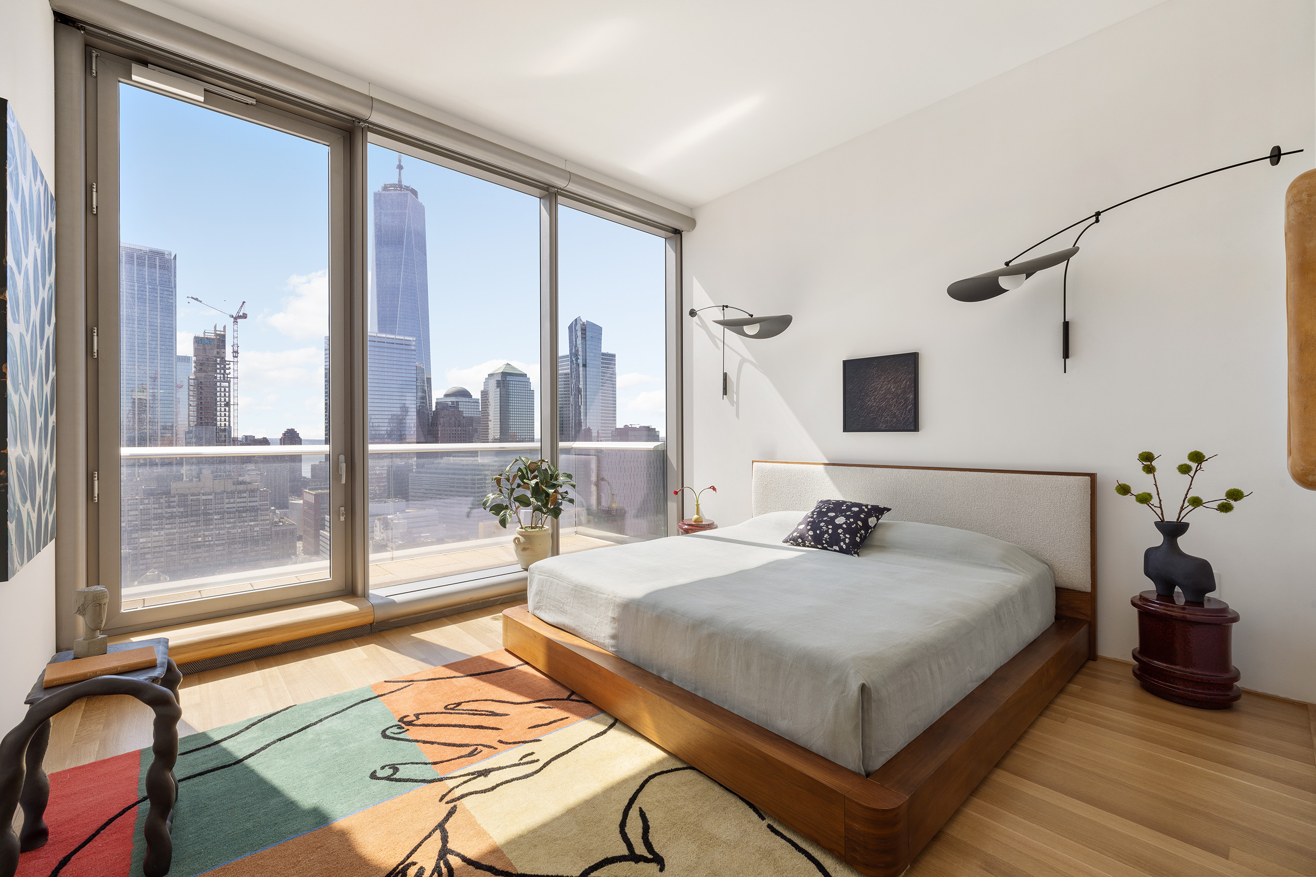 56 Leonard Street, Unit 33AWEST Manhattan, NY 10013 - Photo 6 of 12 a bedroom with a large bed and a chandelier