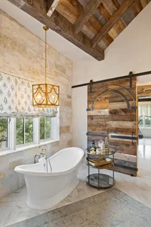 a bathroom with a granite countertop toilet sink and mirror