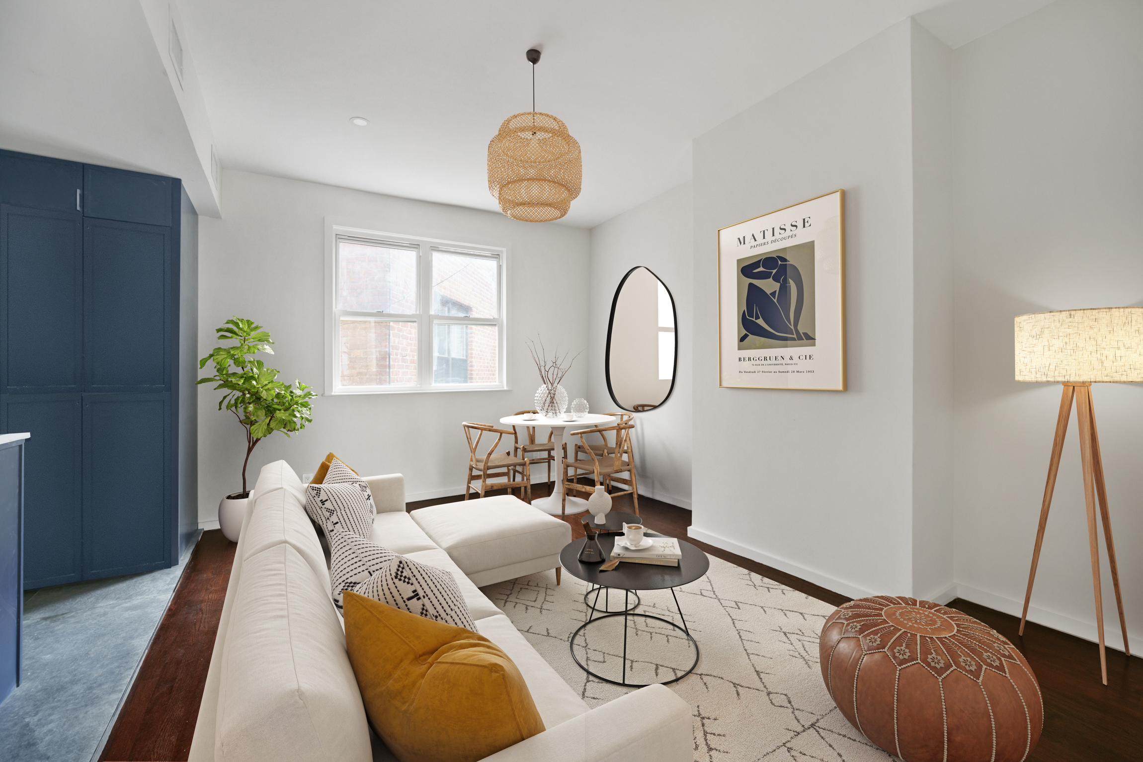 a living room with furniture a clock and a potted plant