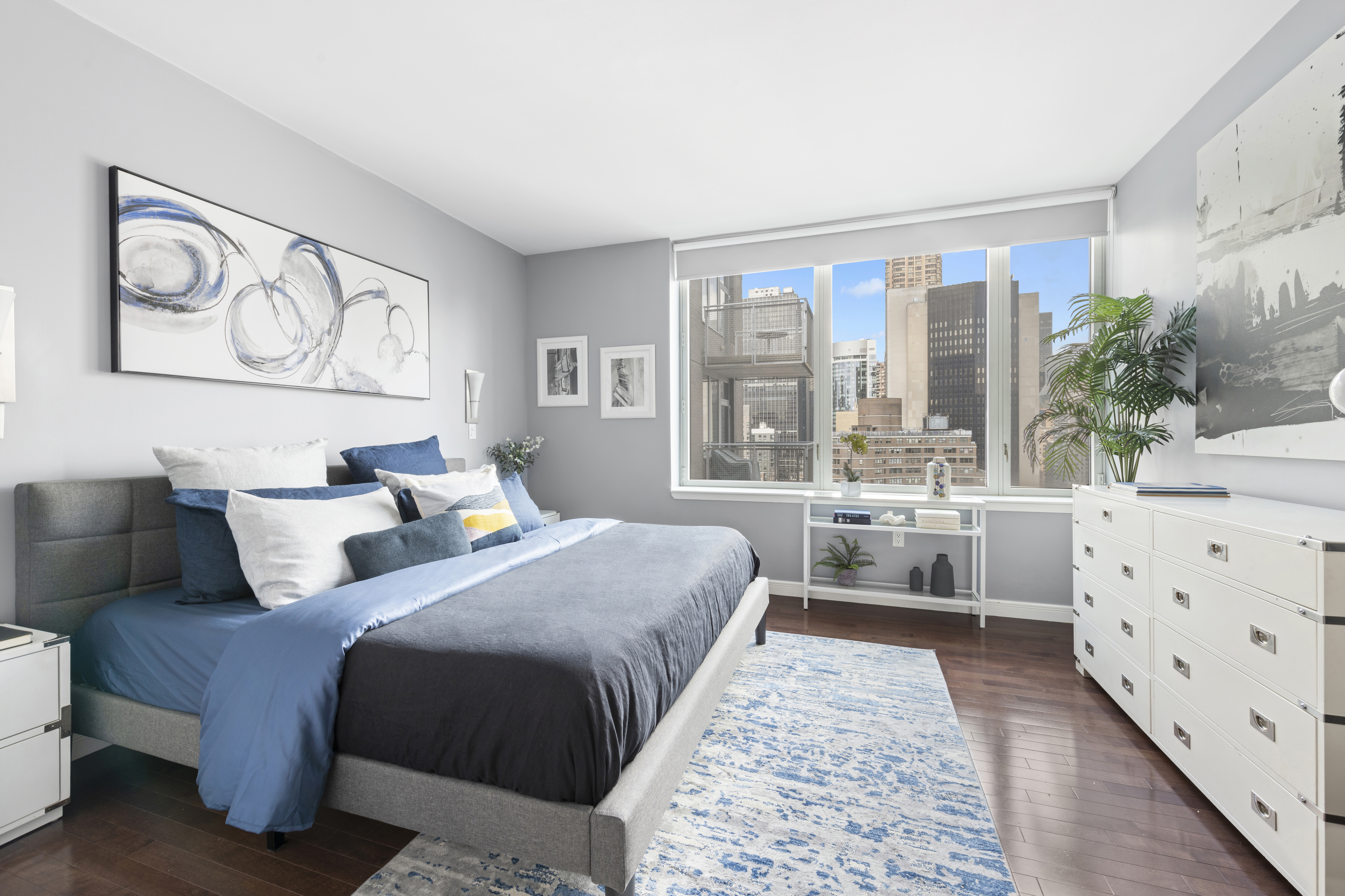 225 East 34th Street, Unit 21I Manhattan, NY 10016 - Photo 7 of 24 a bedroom with double bed and a large window