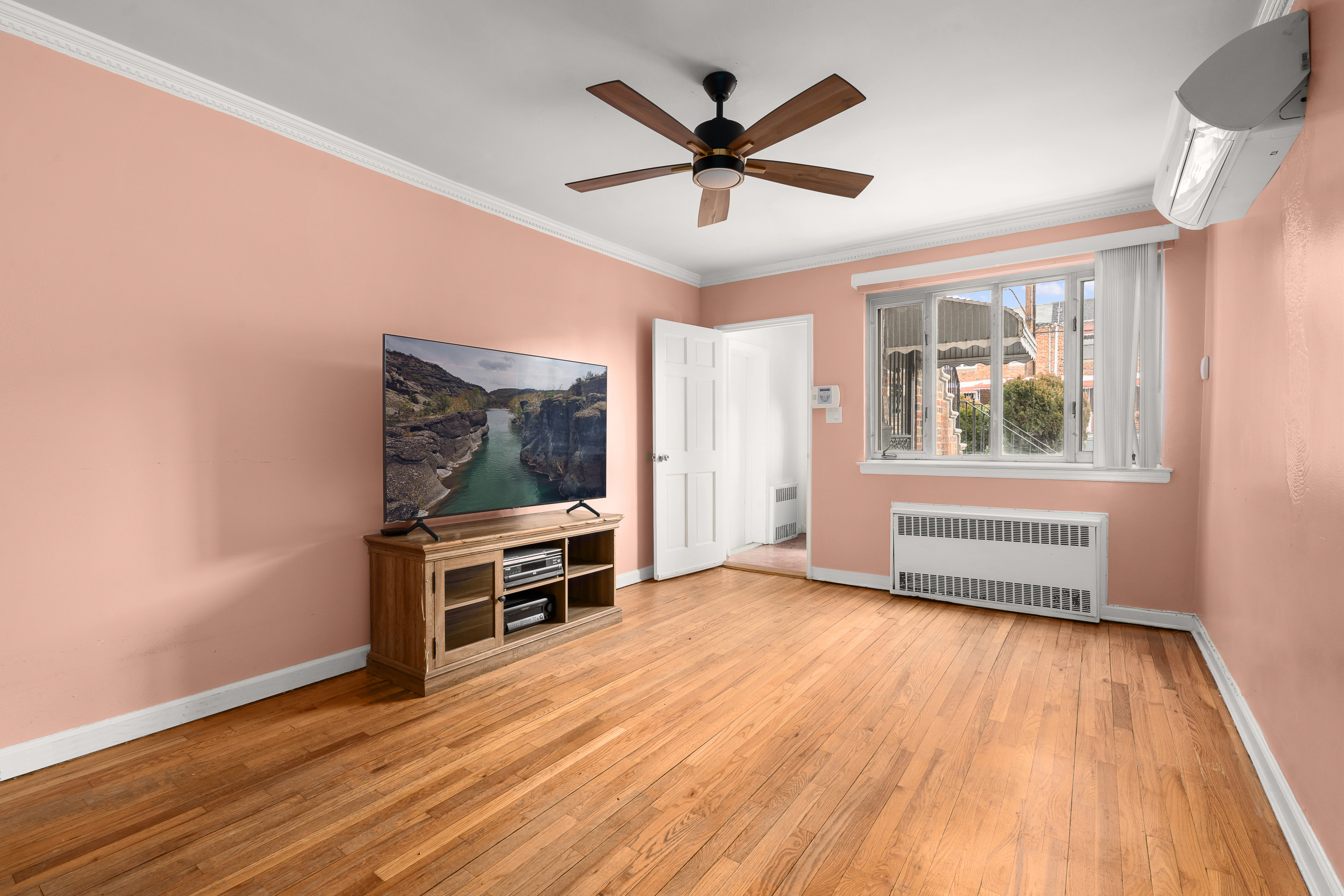 1268 East 52nd Street Brooklyn, NY 11234 - Photo 3 of 13 wooden floor in an empty room with a window