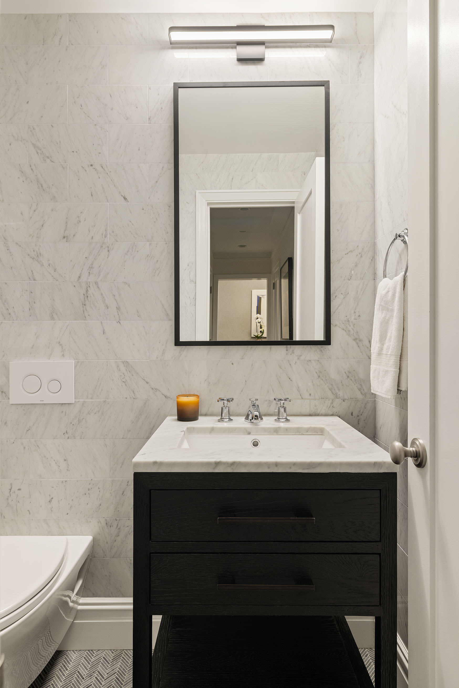 25 Central Park West, Unit 3A Manhattan, NY 10023 - Photo 9 of 11 a bathroom with a toilet sink and mirror