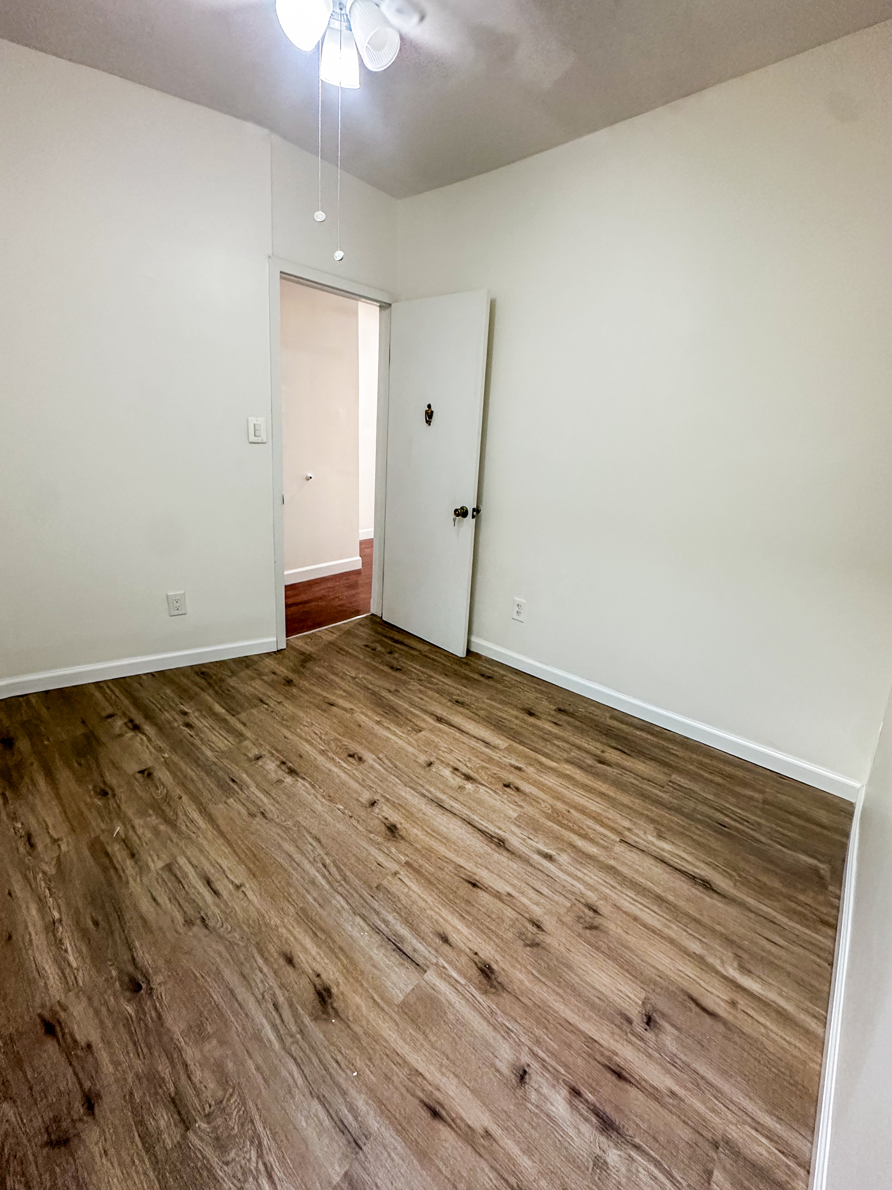 289 A Cooper Street, Unit 2 Brooklyn, NY 11237 - Photo 13 of 19 a view of an empty room with wooden floor