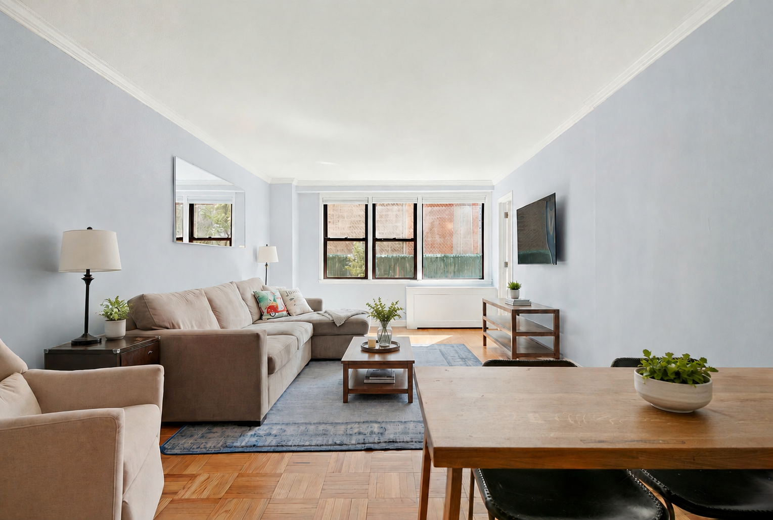 201 East 21st Street, Unit 2FG Manhattan, NY 10010 - Photo 2 of 10 a living room with furniture and a flat screen tv