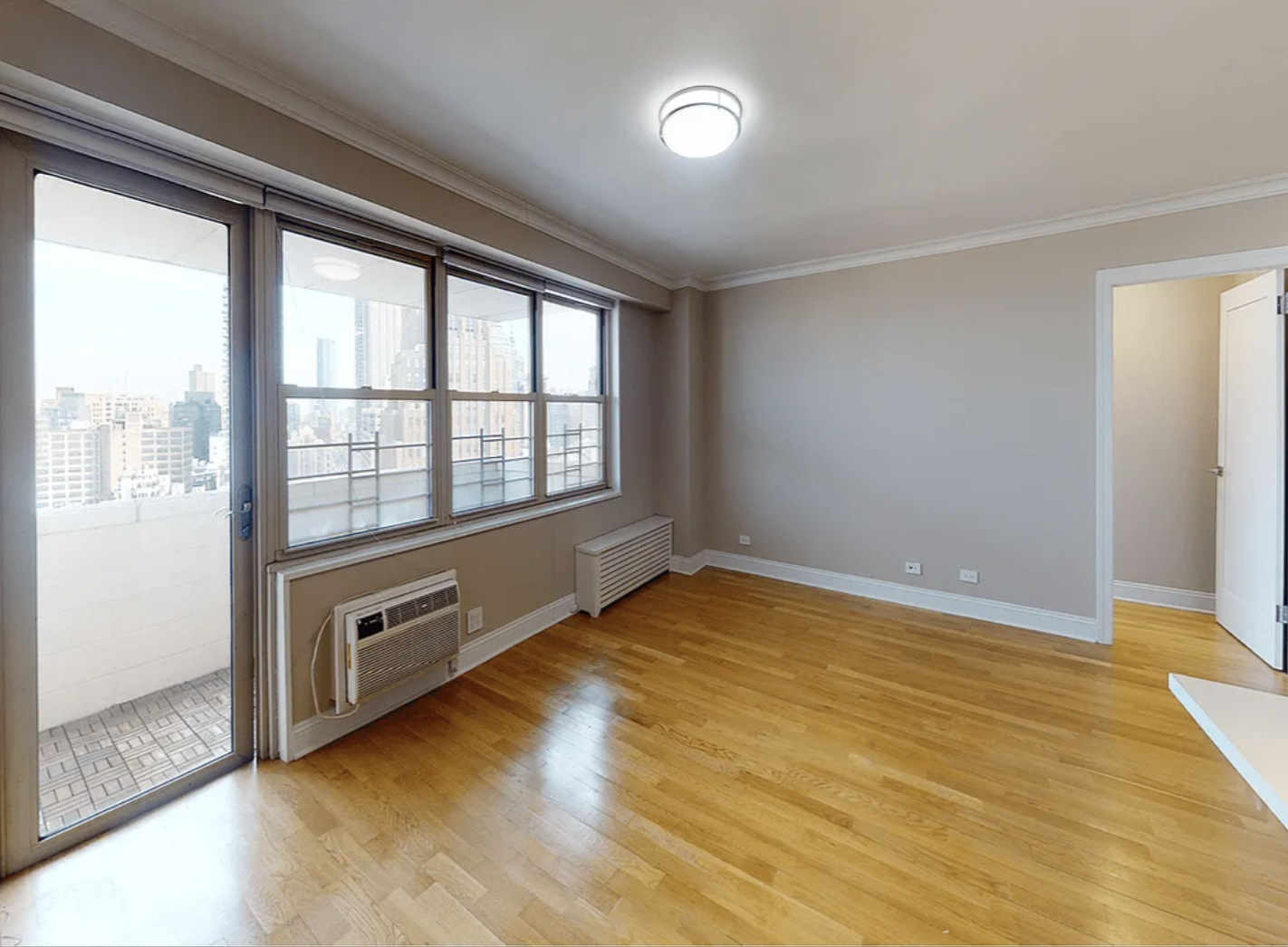 40 Harrison Street, Unit 24H Manhattan, NY 10013 - Photo 3 of 17 wooden floor in an empty room with a window