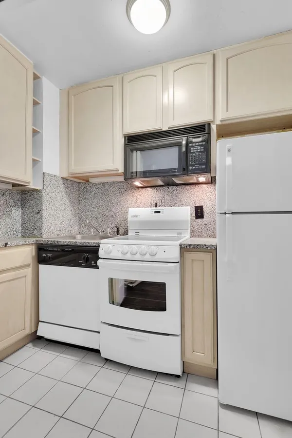 a kitchen with a stove top oven and sink